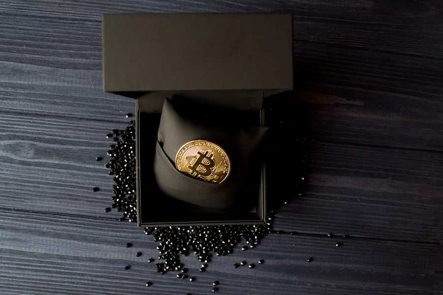 Kultainen bitcoin mustassa laatikossa