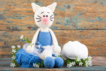 Knitted cat in a blue dress