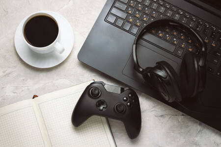Gamepad, laptop and headphones