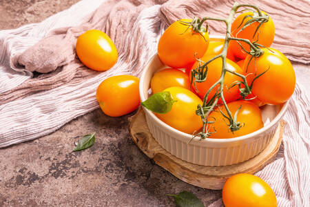 Orange tomatoes in a ceramic bowl