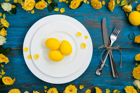 Easter table setting on a blue table