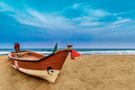 A boat on a sandy beach