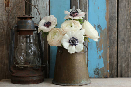 A bouquet of anemones and an old lamp