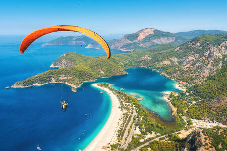 Paragliding, mountains and lagoon