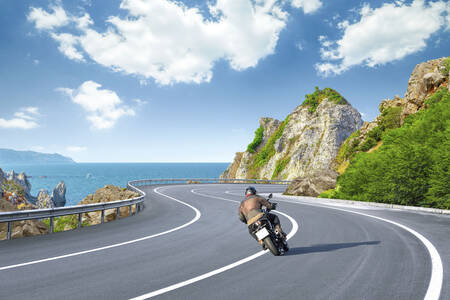 A motorcyclist on a coastal road