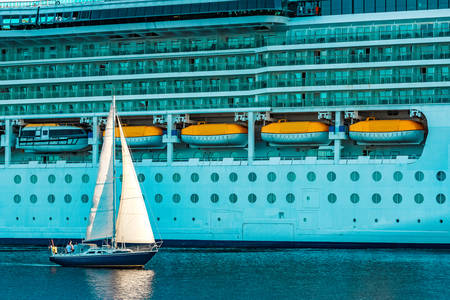 Sailboat with cruise liner
