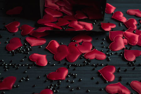 Red hearts on black table