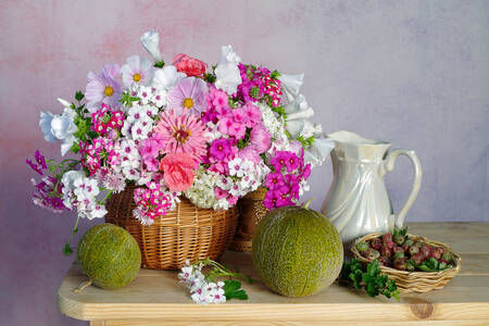 Flowers and melons on the table