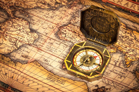 Retro compass on an old map