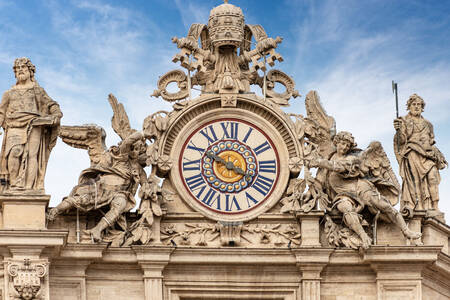 Clock and sculptures on the facade of St. Peter's Basilica in the Vatican