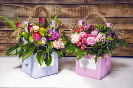 Bouquets of flowers in wooden boxes