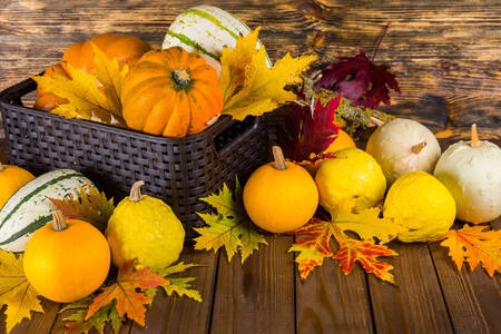 Pumpkins and leaves on a wooden table