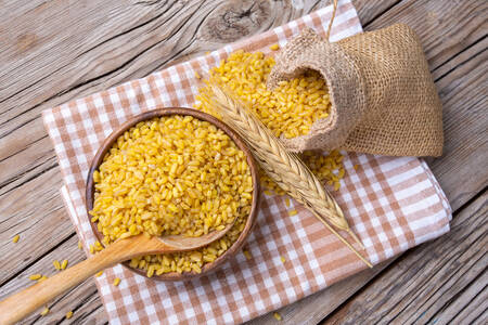 Bulgur on wooden background