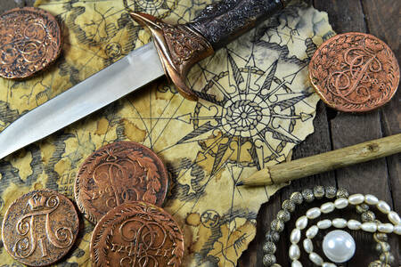 Mapa, adaga e moedas