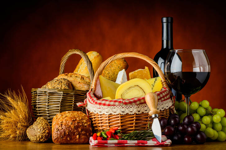 Wine and baskets of cheese and bread