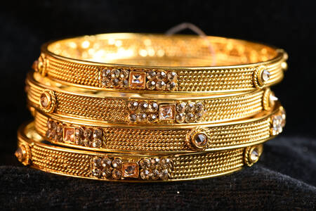 Gold bracelets with precious stones