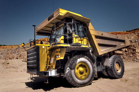 Yellow dump truck in a quarry