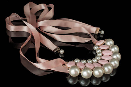 Necklace with pearls on a pink ribbon