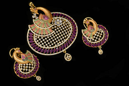 Earrings and pendant on a black background