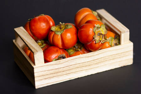 Persimmons in a wooden crate