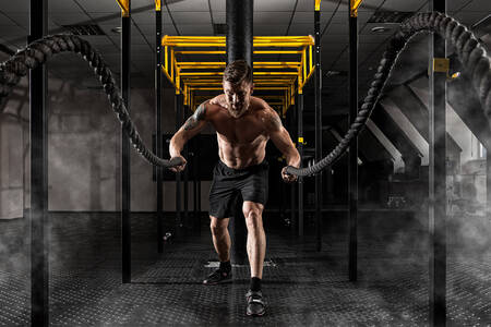 Athlete with battle ropes