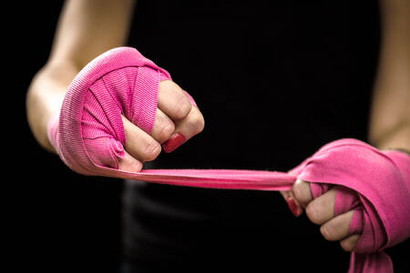 Hands with pink elastic bandages