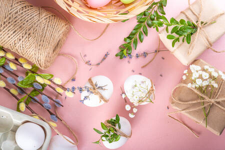 Eier und Blumen auf einem rosa Hintergrund