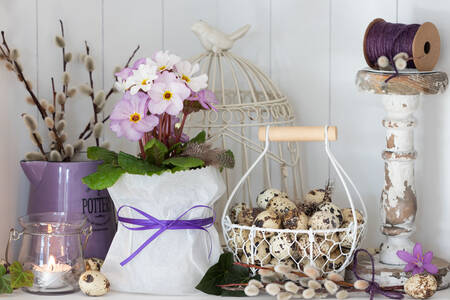 Sebuah keranjang berisi telur dan bunga primrose di atas meja