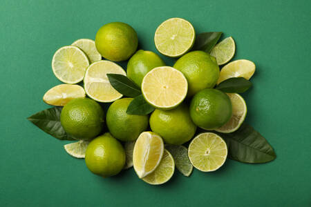Limes on green background