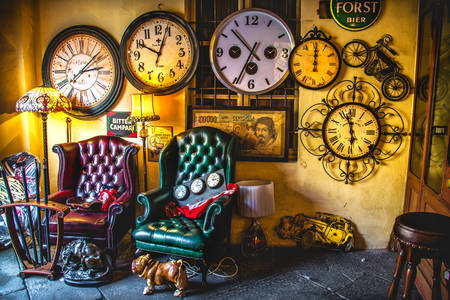 Vintage furniture and wall clock in an antique shop