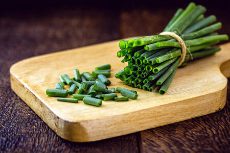 Green onions on a wooden board