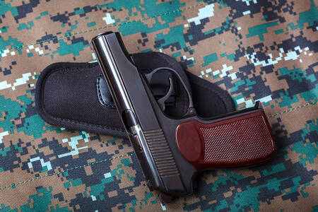 Pistol on a camouflage background