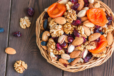 Nuts and dried fruits in a wooden bowl