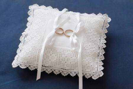Wedding rings on a white pillow
