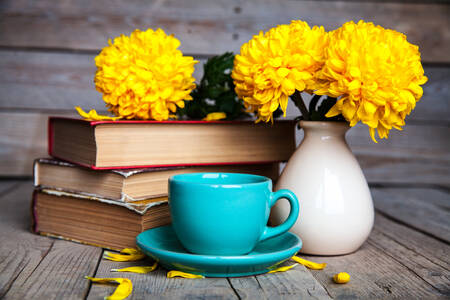 Yellow chrysanthemums and books on the table