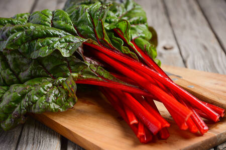 Chard leaves on a wooden board