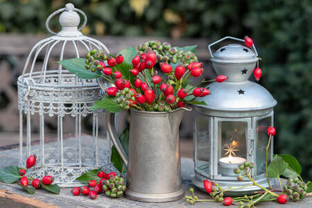 Rose hips in a jug and lanterns