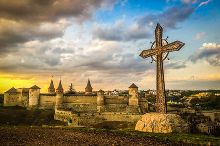 A cross against the backdrop of Kamianets-Podilskyi Castle