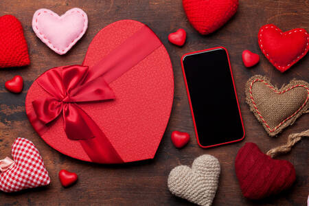 Hearts and smartphone on the table