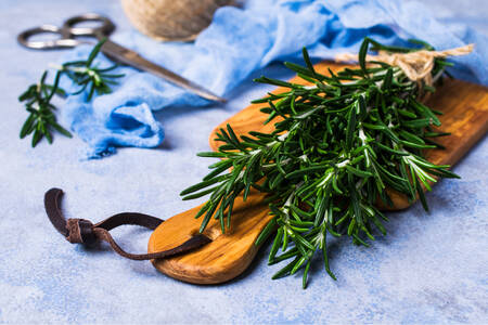 Rosemary sprigs on a wooden board