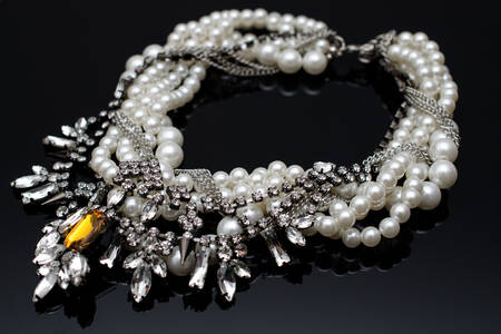 Necklace with pearls on a black background