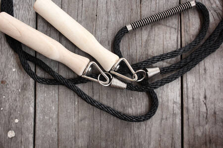 Skipping rope on wooden background