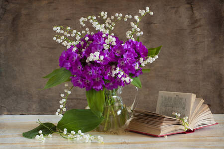 Blumenstrauß und Buch auf dem Tisch