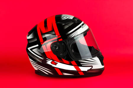 Motorcycle helmet on red background