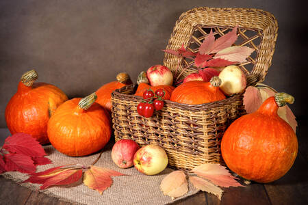 Pumpkins and apples in a basket
