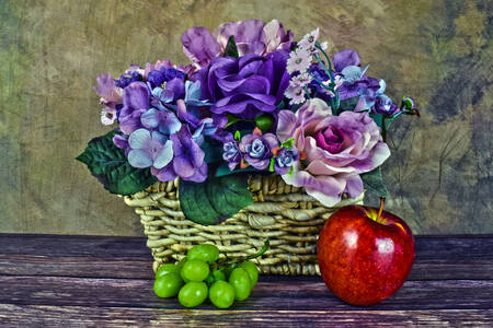Basket of flowers with grapes and apple