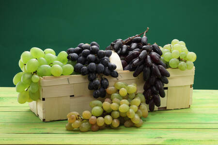 Blue and white grapes in a basket