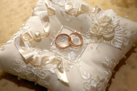 Wedding rings on a decorative cushion