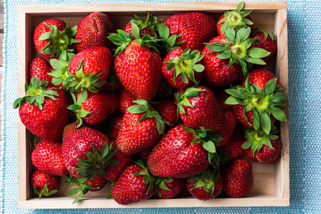 Ripe strawberries in a wooden box