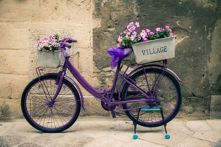 Purple bicycle with flowers